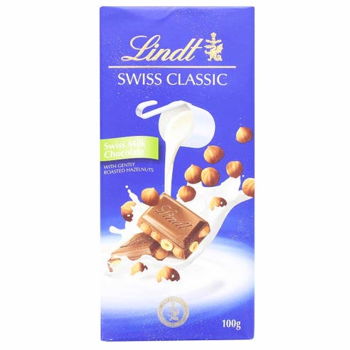 Lindt Swiss Classic Milk Chocolate With Hazelnut 100g - Available at Alosra Online Supermarket